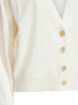 Cardigan in cashmere avorio con monile