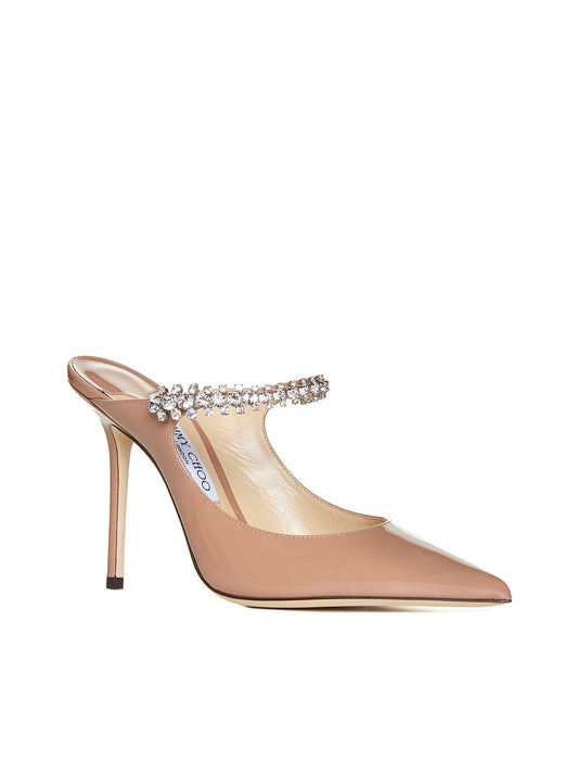 Pastel pink patent leather mules with crystal strap