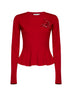 Maglia in lana rossa con spilla a forma di rosa in vernice